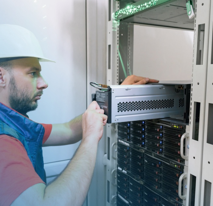 CPG Man installing battery in data server