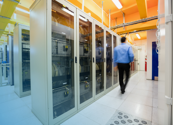 CPG Blurred person walking through data center hallway